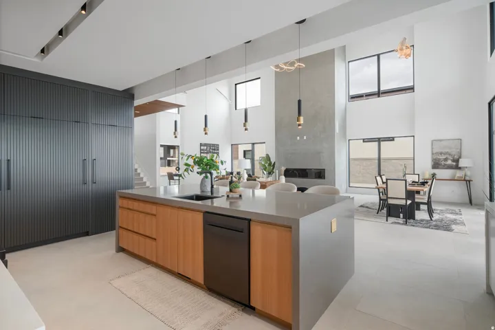 Gourmet kitchen with a large central island, integrated appliances, and floor-to-ceiling cabinetry