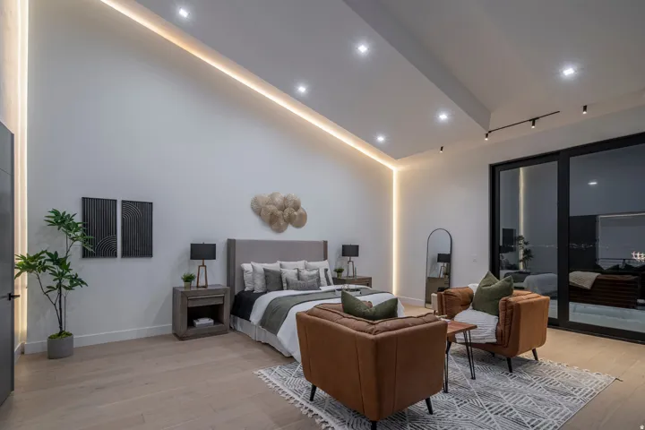 Vaulted ceiling with recessed lighting and cove lighting