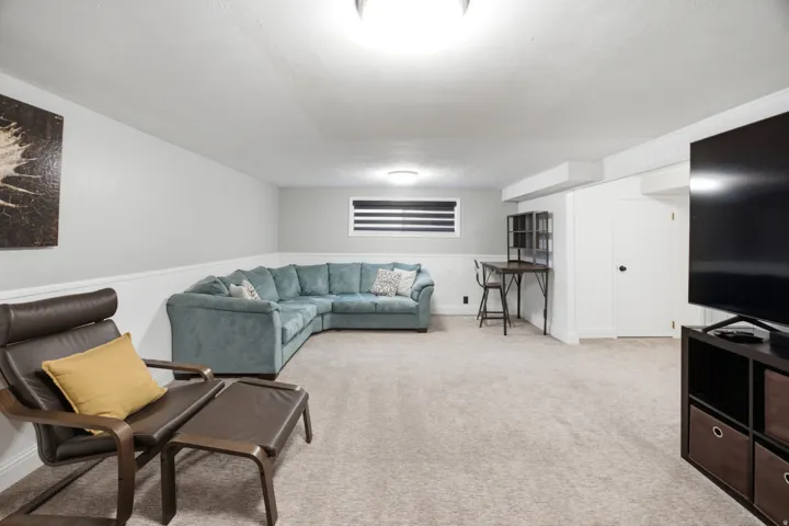 Recessed lighting, wall-to-wall carpeting, and a white chair rail molding