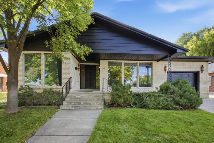 Brick exterior with dark trim and an integrated garage
