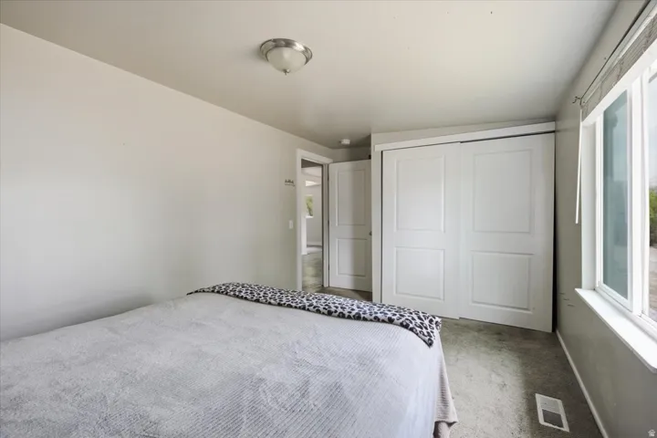 Recessed lighting, large window, and sliding closet doors