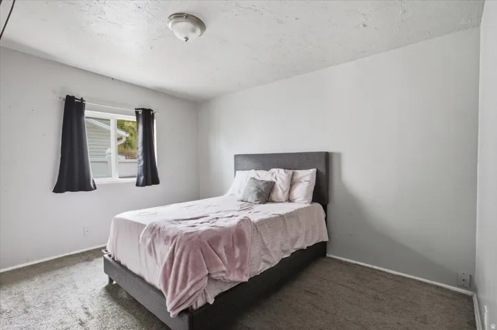 Recessed window with white trim, wall-to-wall carpeting, white painted walls, and a ceiling-mounted light fixture