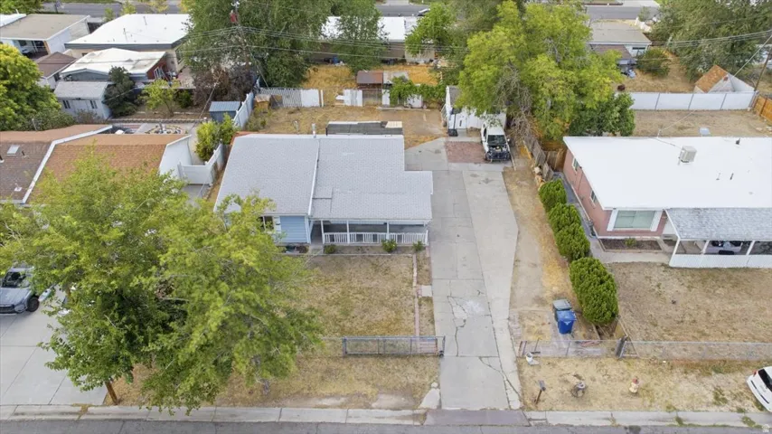 Single-story residence with a light-colored roof, covered front porch, and a paved driveway
