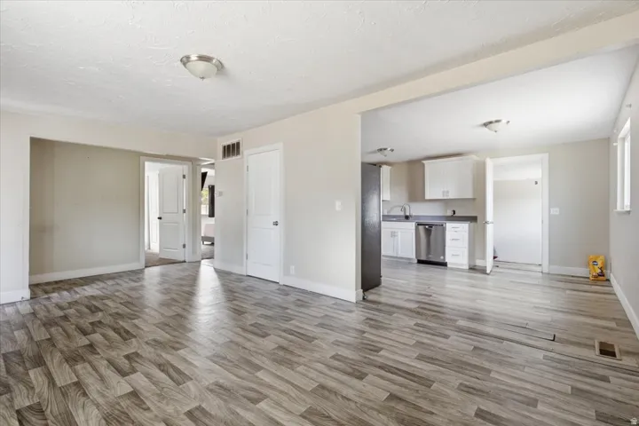 Open-concept living area with wood-finish flooring