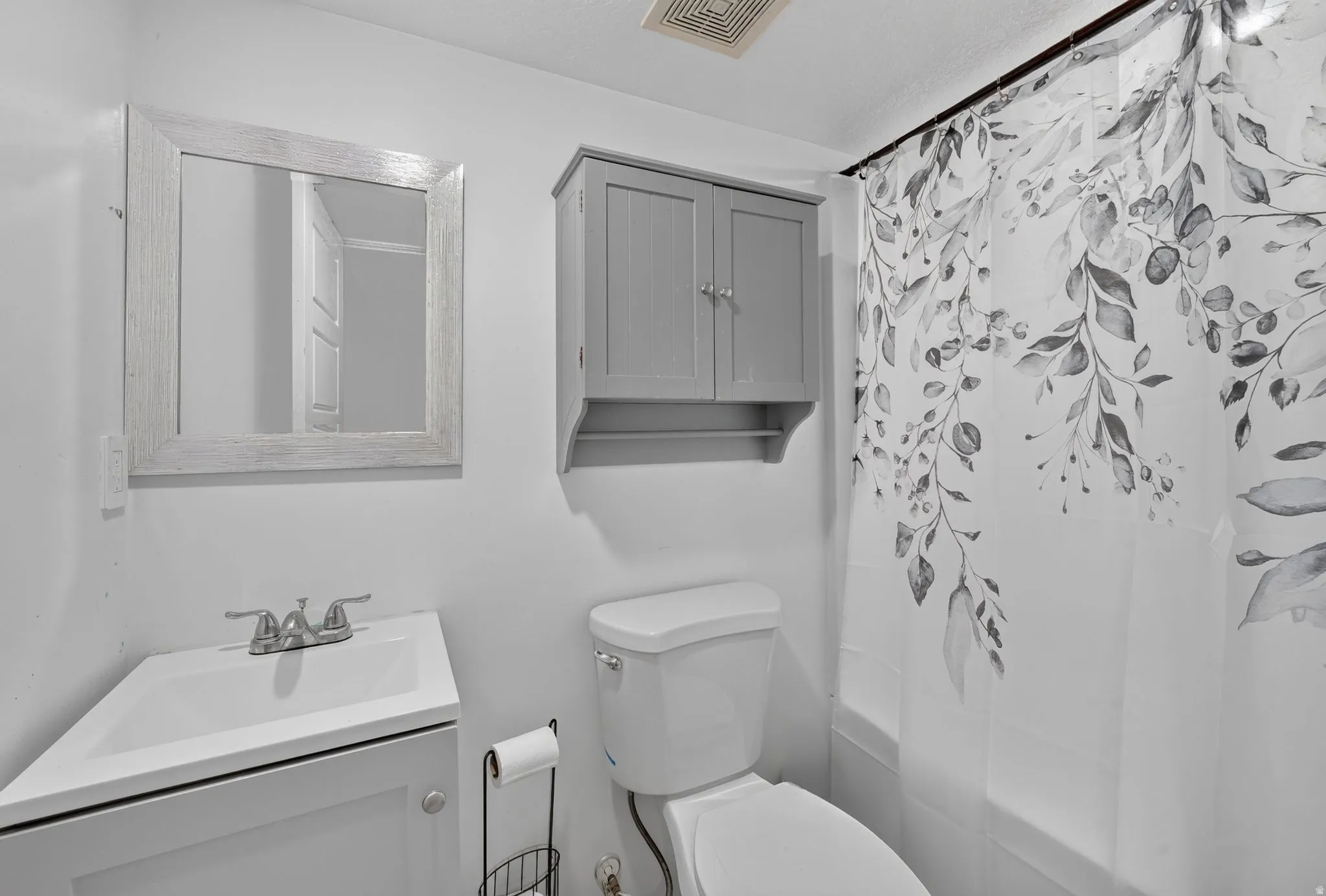 White vanity with integrated sink and chrome faucet