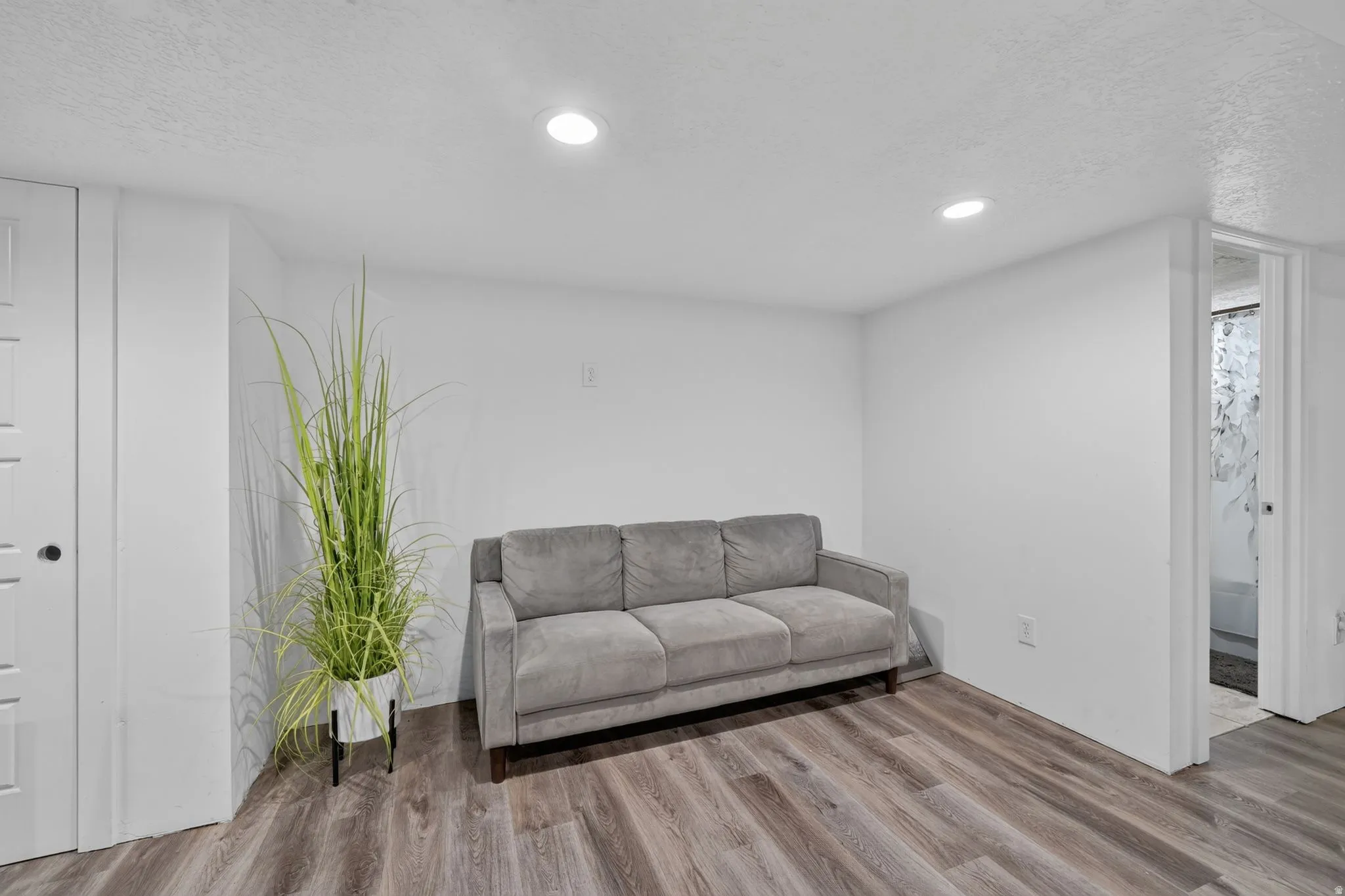 Wood-finish flooring, recessed lighting, and a neutral color palette