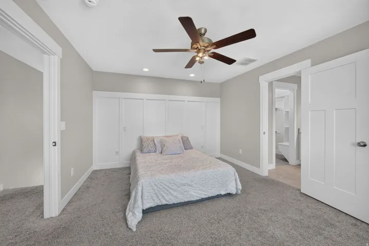 Wall-to-wall carpeting, recessed ceiling lighting, and a ceiling fan with integrated lighting