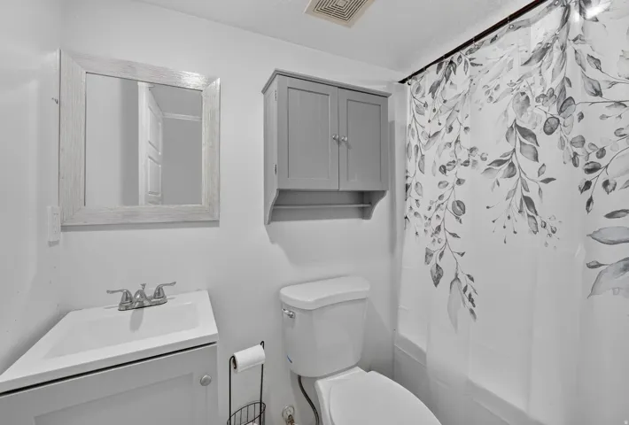 White vanity with integrated sink and chrome faucet