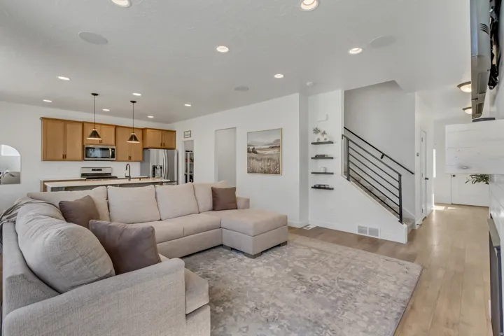 Open-concept living space featuring wood-finish flooring and recessed lighting