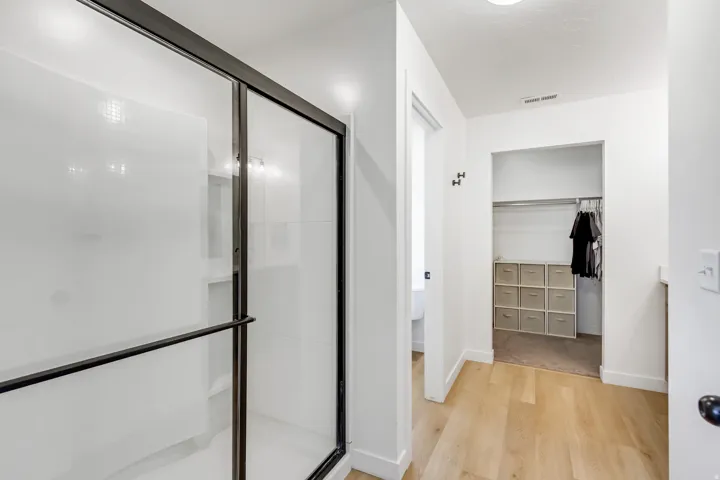Shower enclosure with black-framed glass and white tile surround