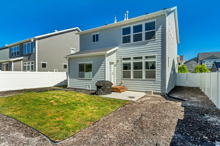 Modern home featuring a clean-lined exterior with horizontal siding, expansive multi-pane windows flooding the interior with natural light, and a well-proportioned rear elevation