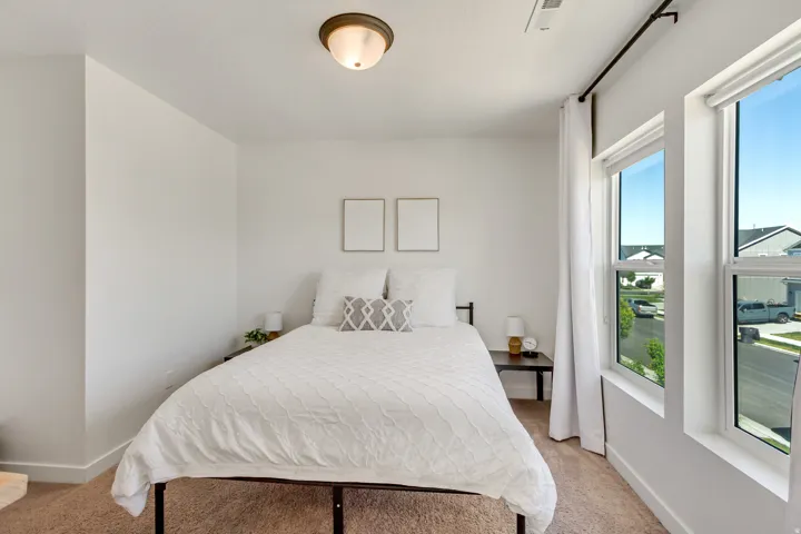 Neutral wall color, wall-to-wall carpeting, semi-flush mount ceiling light, and multiple windows