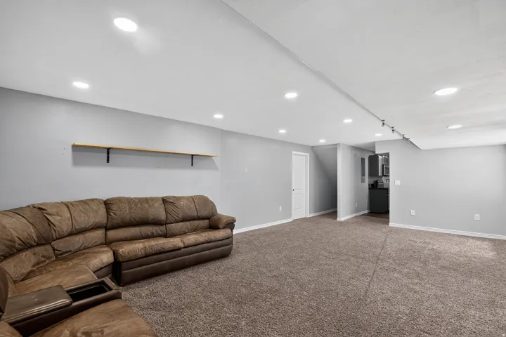 Spacious interior with neutral gray walls and brown carpeting