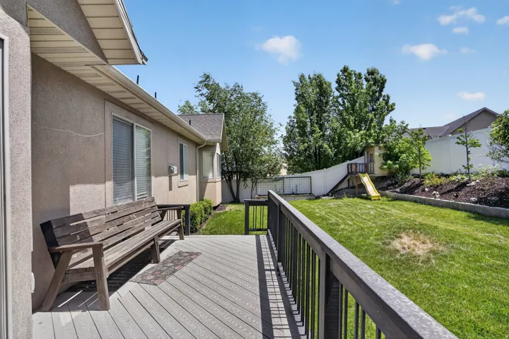 Expansive outdoor deck featuring wood-finish composite decking and a dark railing