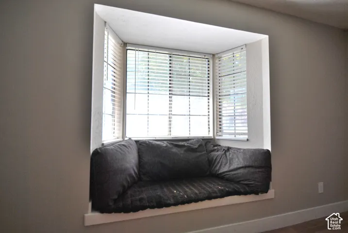 Recessed window bay with integrated seating platform (storage below) and white window blinds