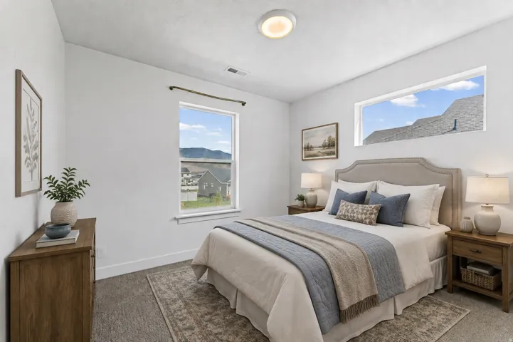 Carpeted flooring, white walls, and a flush mount ceiling light