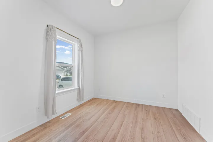 Recessed ceiling light, white walls, and wood-finish flooring