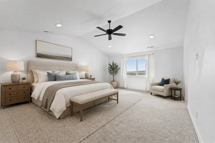 Vaulted ceiling with recessed lighting and a ceiling fan