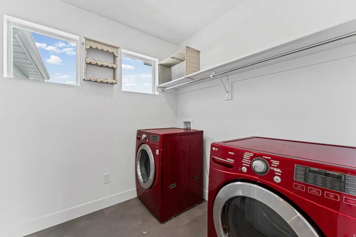 Utility space featuring white walls and wood-finish flooring