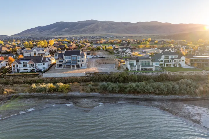 Expansive residential area with water frontage and mountain backdrop