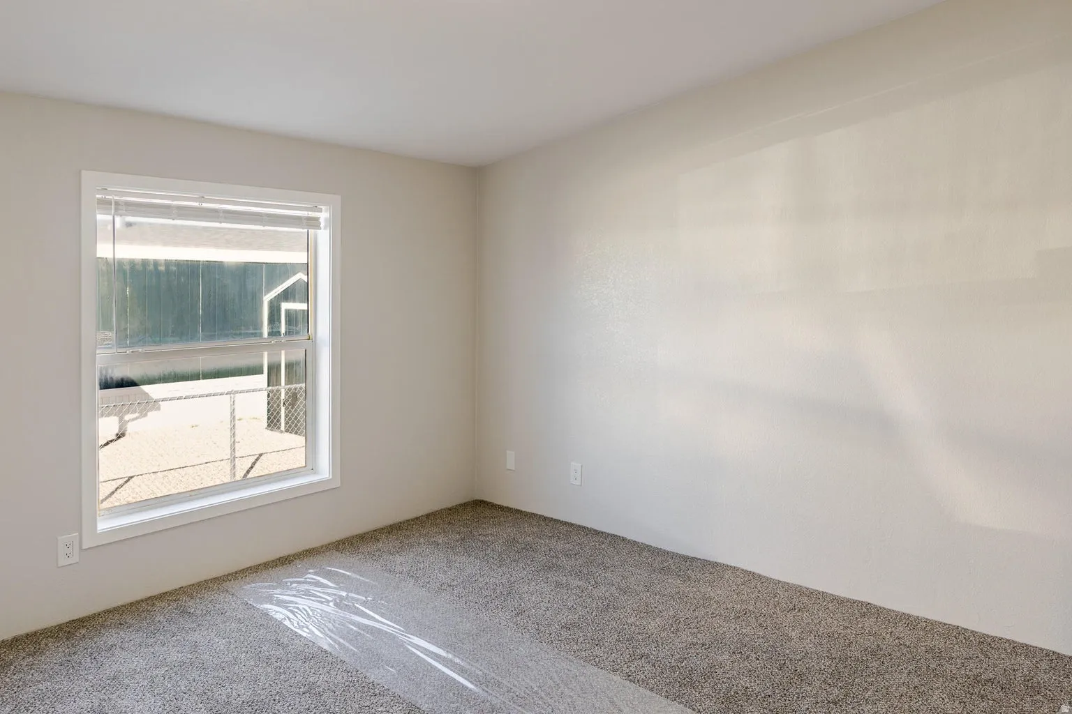 Neutral wall finish and carpeted flooring