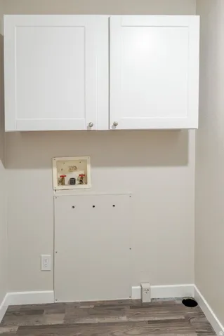 Shaker-style upper cabinetry with brushed nickel hardware, wood-finish flooring, and white wall finishes