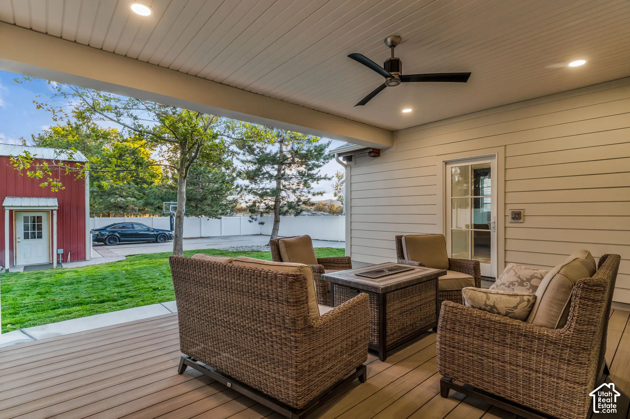 Covered patio with recessed lighting, ceiling fan, and composite decking