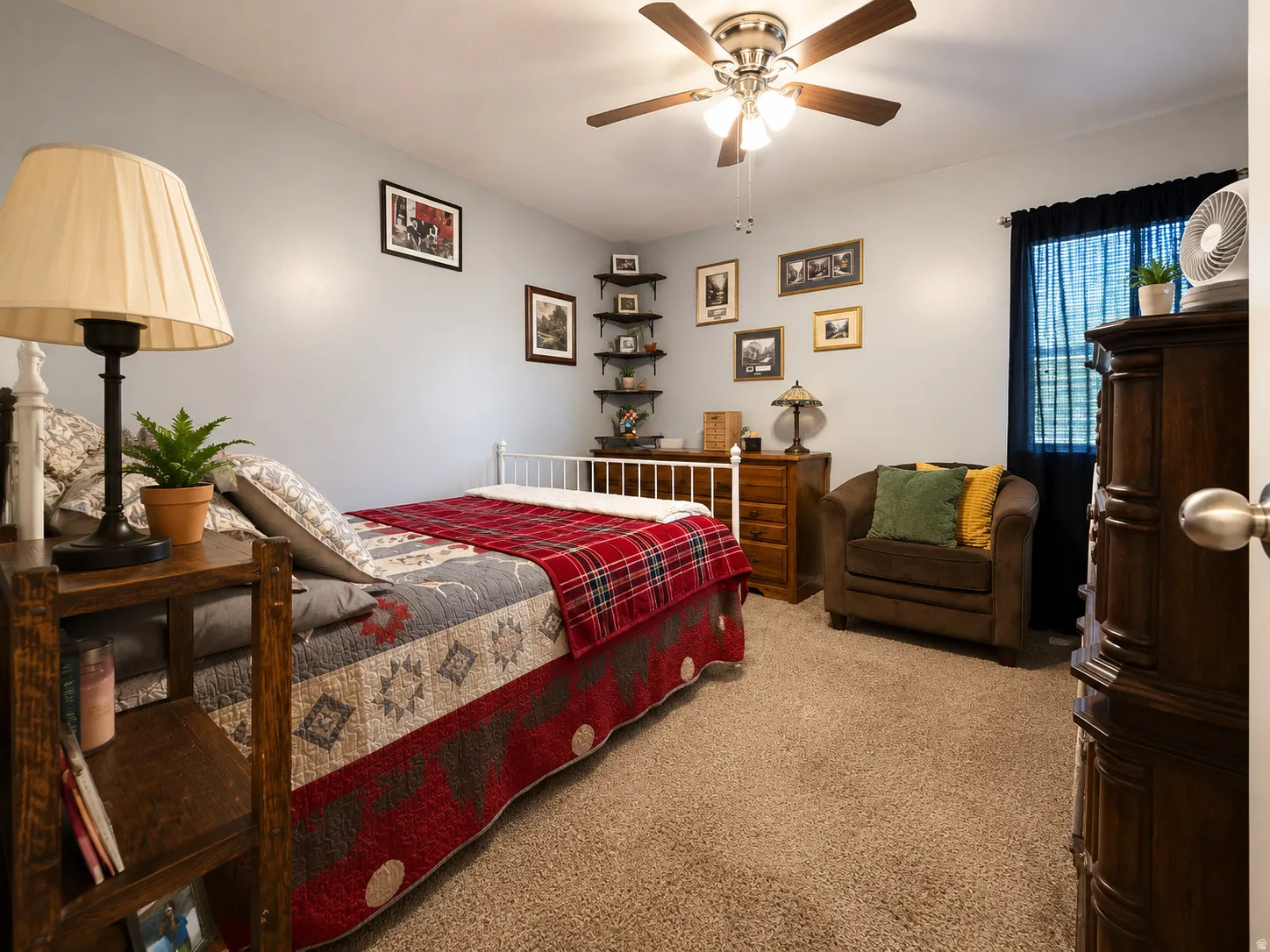 Wall-to-wall carpeting, ceiling fan with integrated lighting, window with dark curtain rod, and light-colored walls