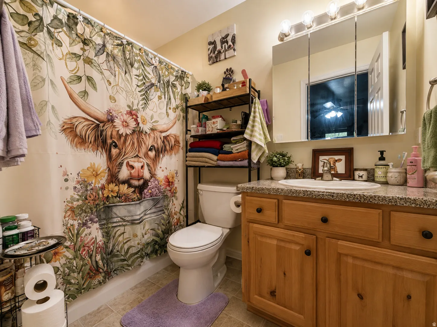 Vanity with a granite-style countertop, undermount sink, and wood-finish cabinetry