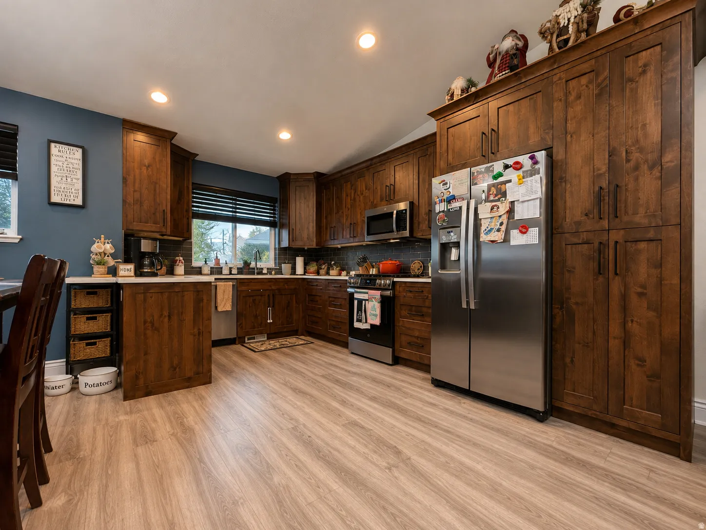 Kitchen featuring dark wood cabinetry, stainless steel appliances, and recessed lighting