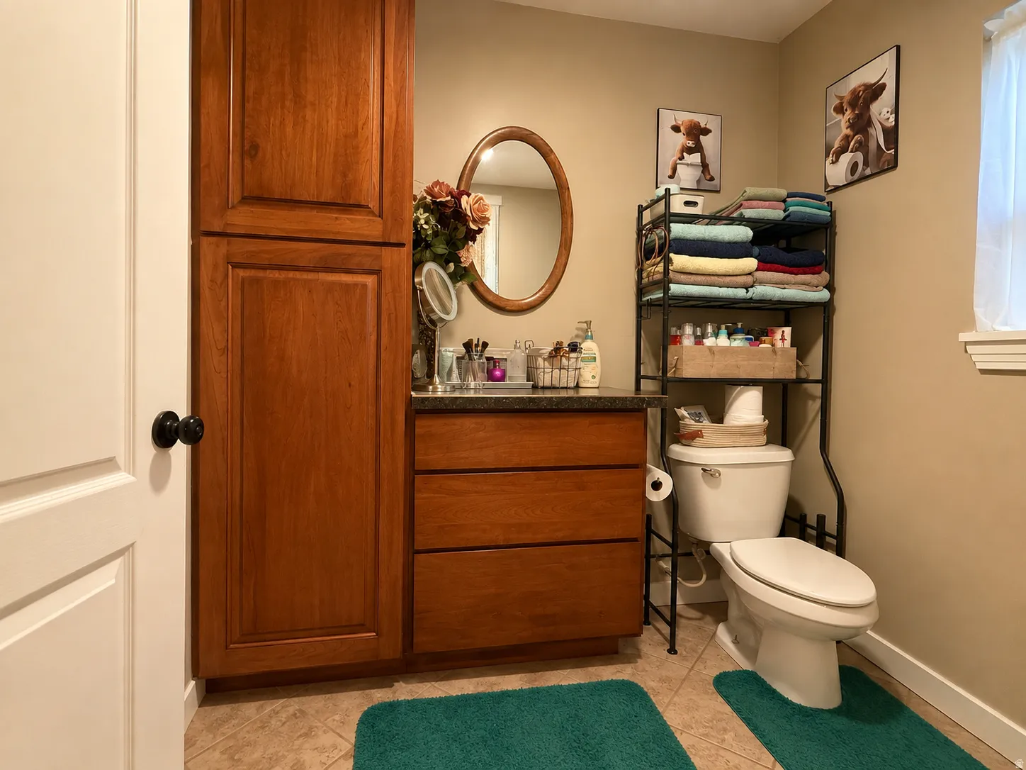 Wood-finish cabinetry and vanity with a dark countertop