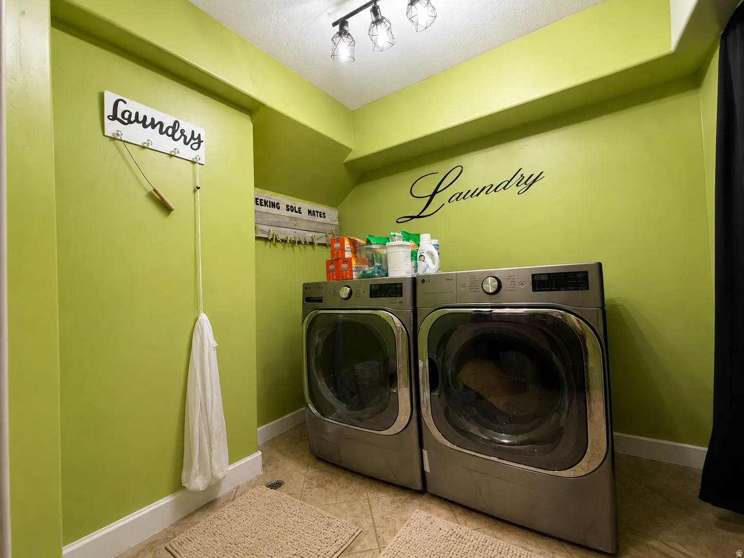 Tile flooring, track lighting, and green painted walls