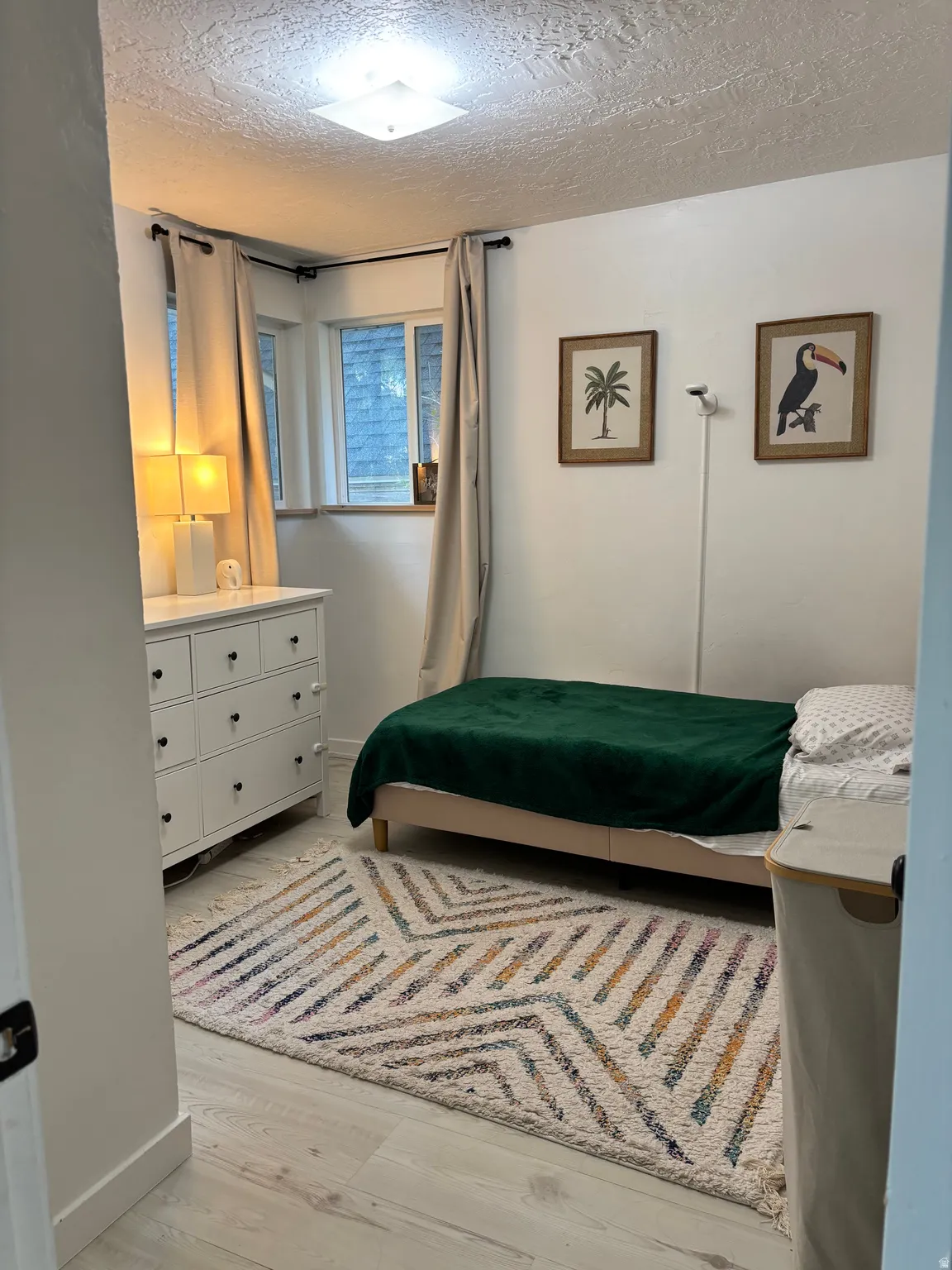 White walls complement the light wood-finish flooring and white trim