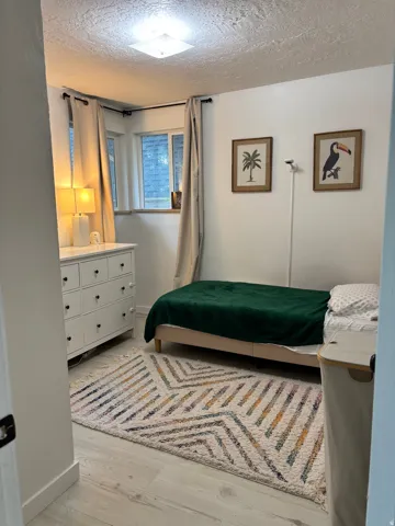 White walls complement the light wood-finish flooring and white trim