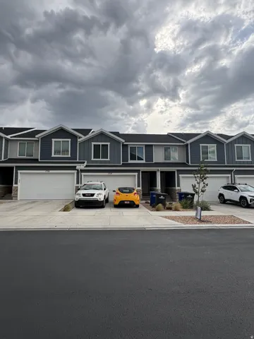 Contemporary townhome exterior with dark siding and white trim