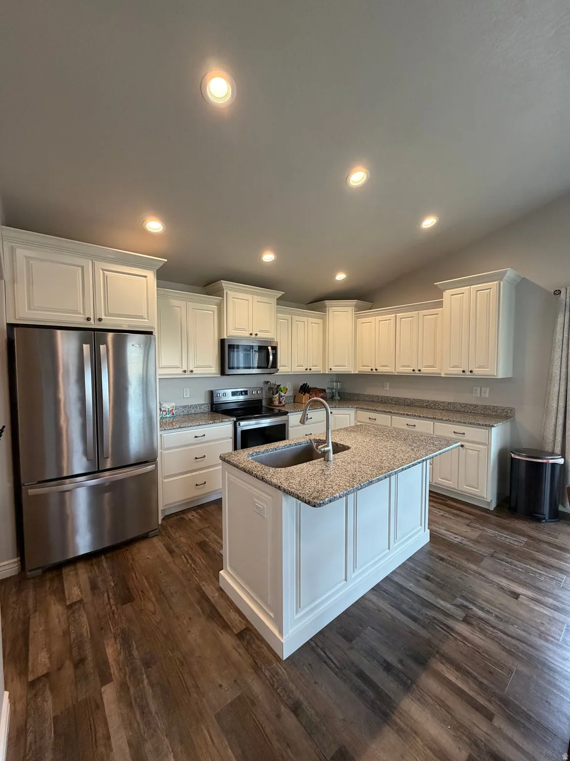 Kitchen featuring large Farm Sink, granite countertops, stainless steel appliances.
