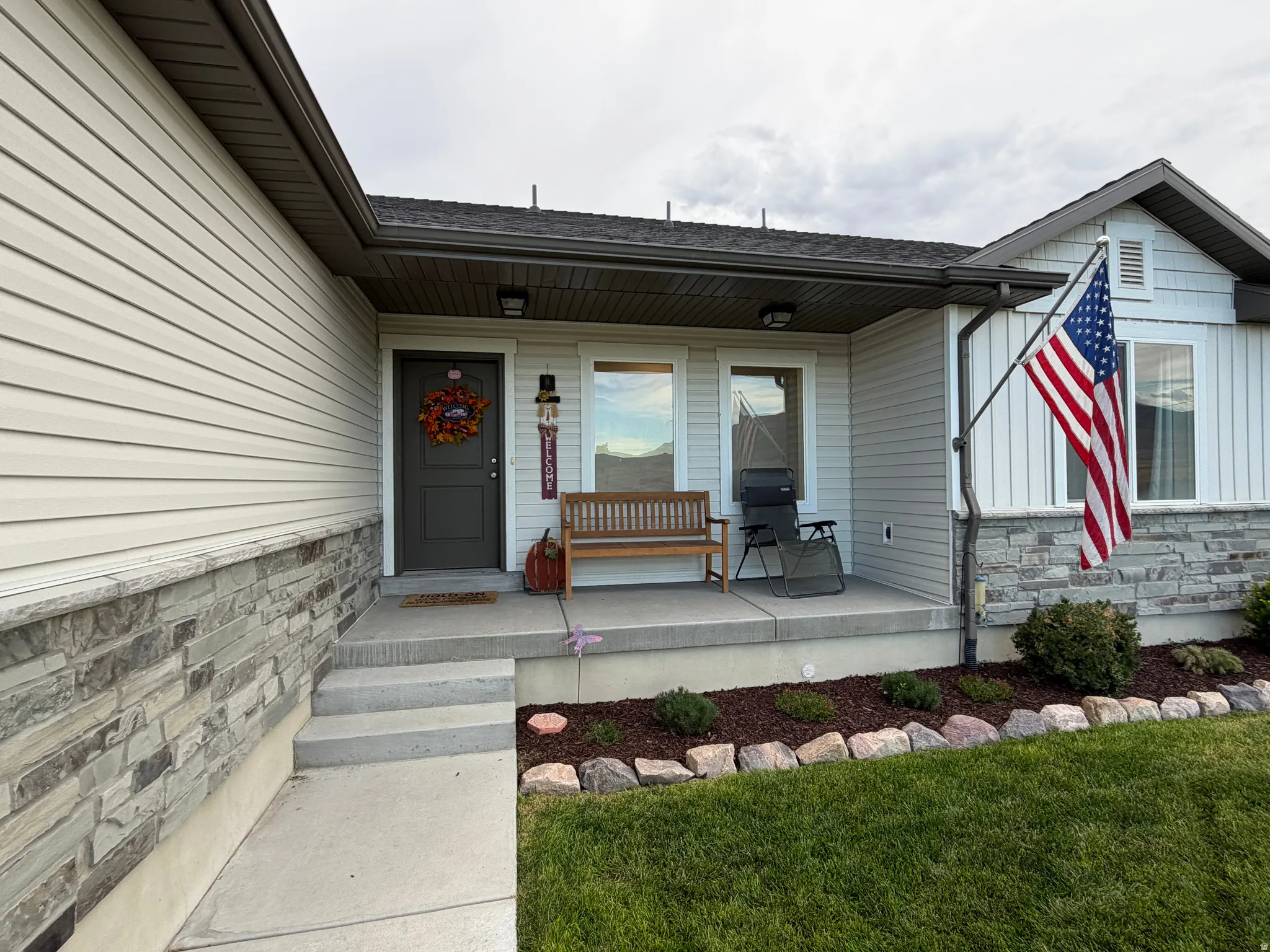 Covered front porch with concrete steps