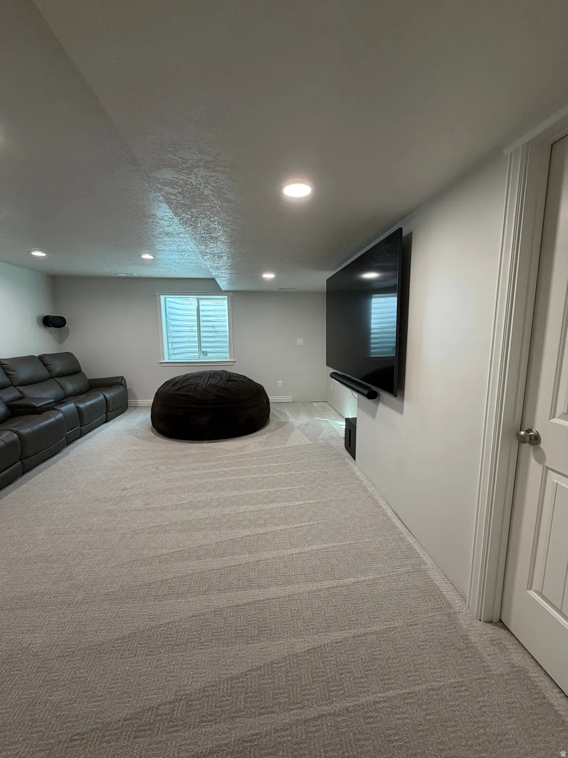spacious family/media room wired for a Sonos home theater system and room for that large flat screen TV ( TV, electronics, and Sonos home theater system excluded)