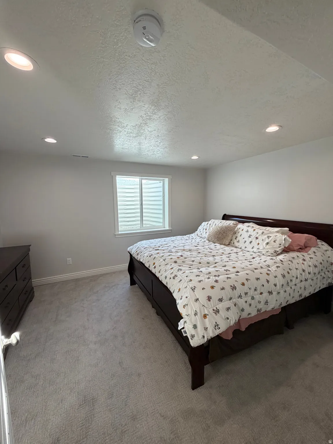 Bedroom 3: Basement large bedroom with plush carpet flooring and shown with king size bed