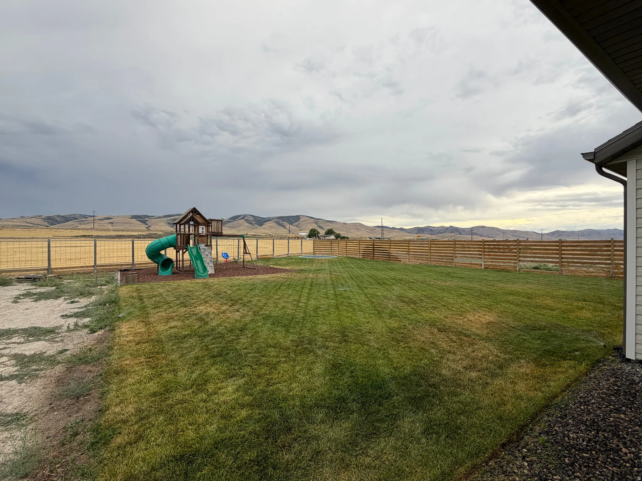 Expansive Backyard lawn area, Playset,and  in-ground trampoline and amazing views