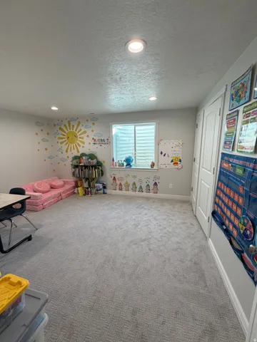Bedroom 4: Large basement Bedroom  with large double closet doors and plush carpet flooring.