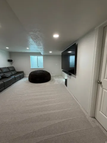 spacious family/media room wired for a Sonos home theater system and room for that large flat screen TV ( TV, electronics, and Sonos home theater system excluded)