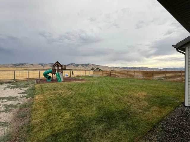Expansive Backyard lawn area, Playset,and  in-ground trampoline and amazing views