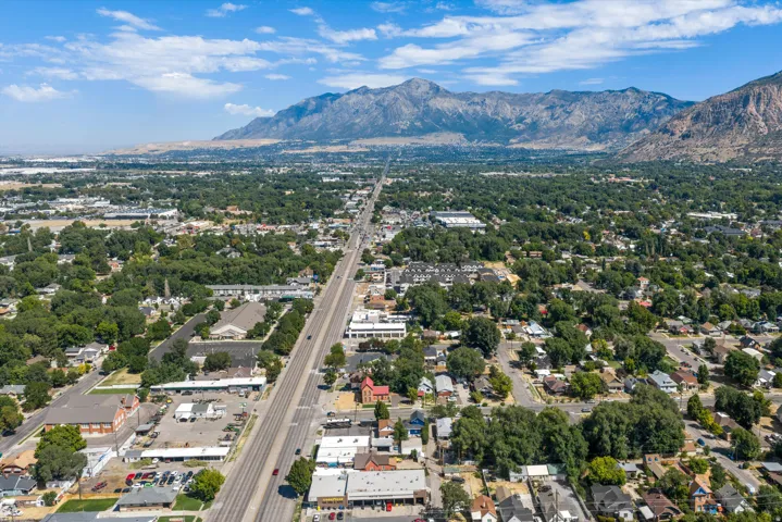 Expansive residential area with abundant mature trees and mountainous terrain