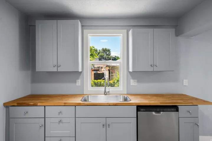 Wood-finish countertops with an undermount stainless steel sink