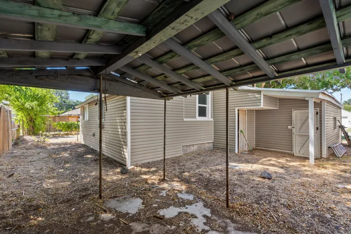 Covered patio structure with metal roofing and exposed wood beams