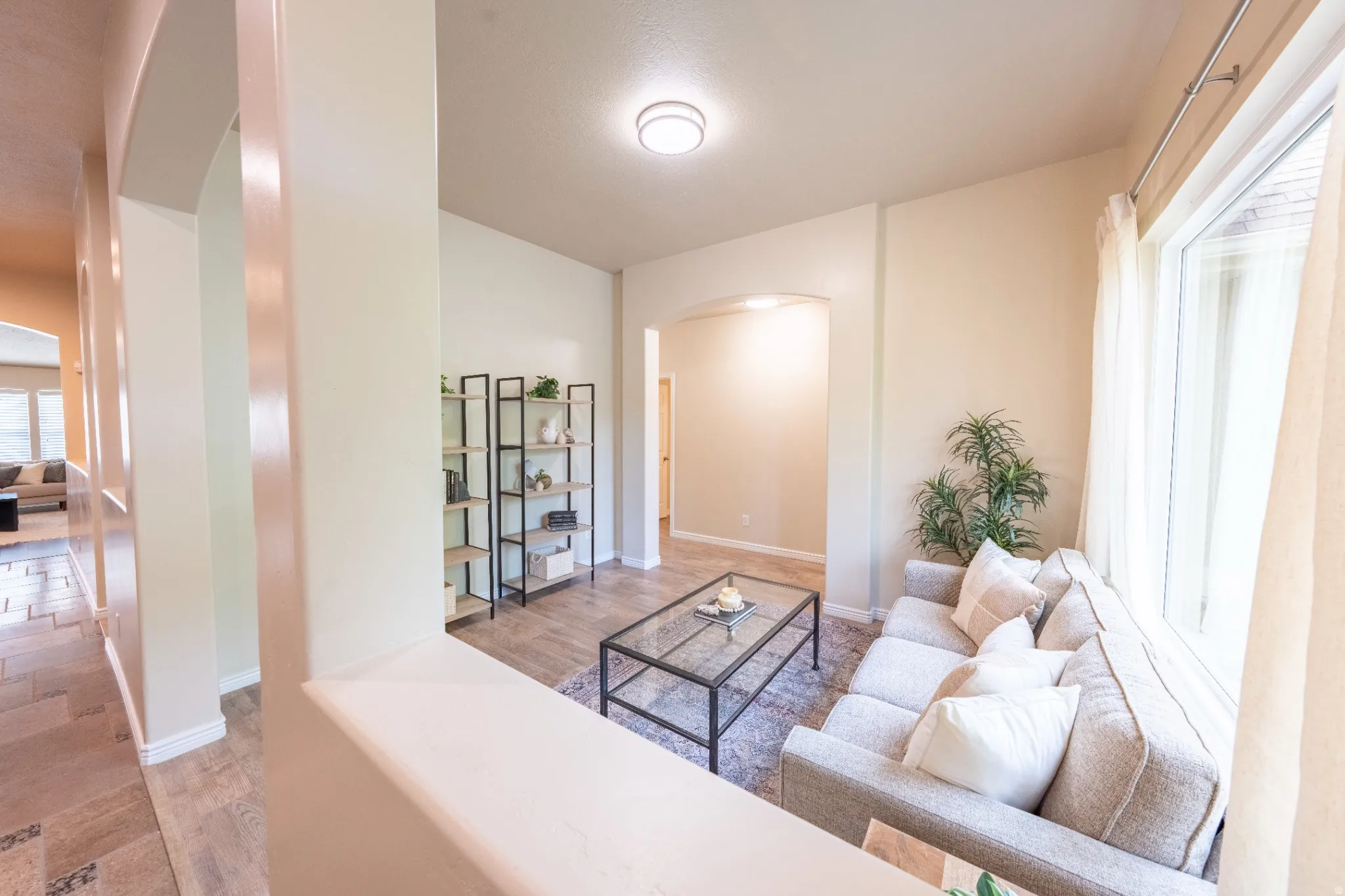 Arched doorways, recessed lighting, and wood-finish flooring