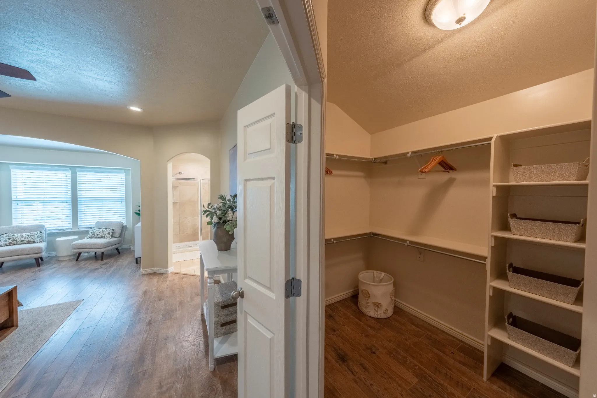 Walk-in closet with built-in shelving and hanging rods