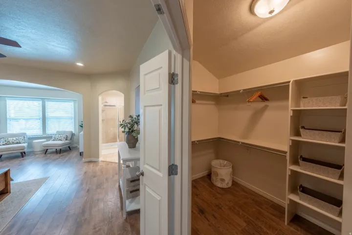Walk-in closet with built-in shelving and hanging rods
