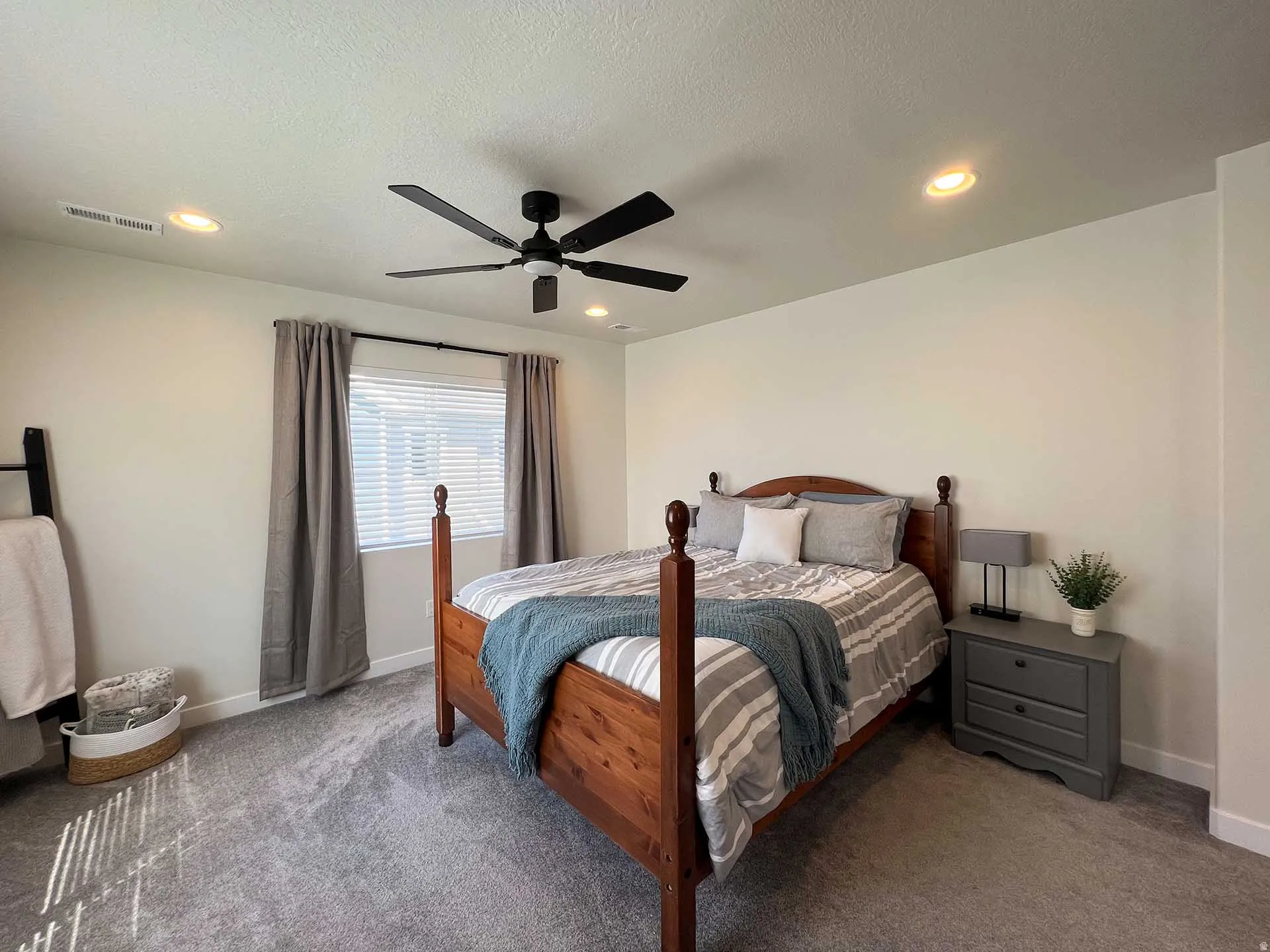 Recessed ceiling lighting, ceiling fan fixture, window with blinds, and gray carpet